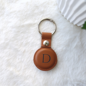 a airtag keyring , with a engraved letter